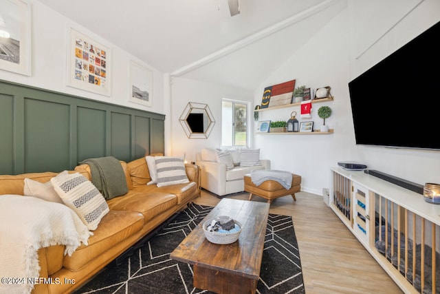 living room featuring light hardwood / wood-style floors and vaulted ceiling