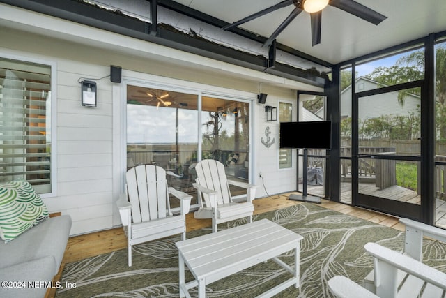 sunroom featuring a wealth of natural light and ceiling fan