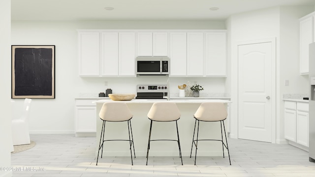 kitchen with white cabinets, white stove, and a center island with sink