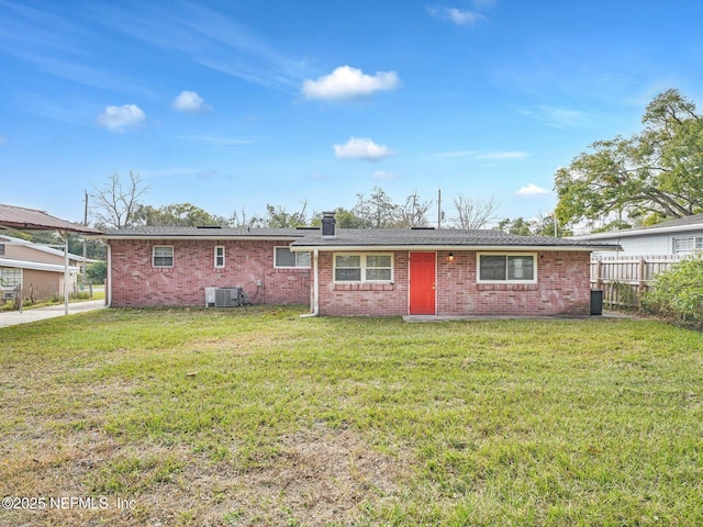 view of front of home featuring a front yard and central air condition unit