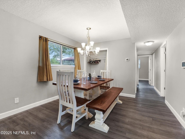 dining area with dark hardwood / wood-style flooring, a textured ceiling, and a chandelier