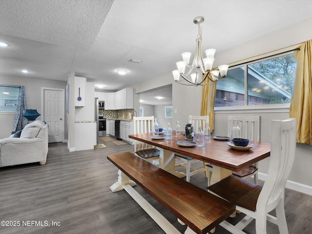 dining space with dark hardwood / wood-style flooring, sink, plenty of natural light, and a notable chandelier