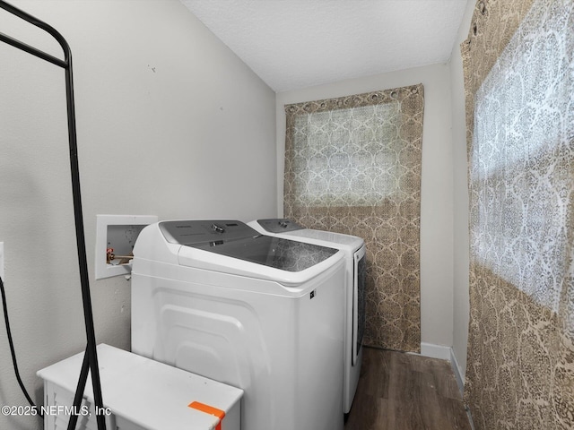 washroom with washer and clothes dryer, hardwood / wood-style floors, and a textured ceiling