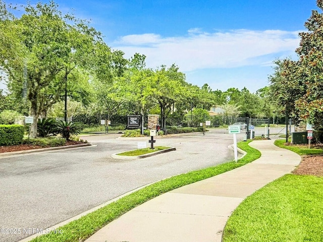 view of home's community featuring fence and a gate