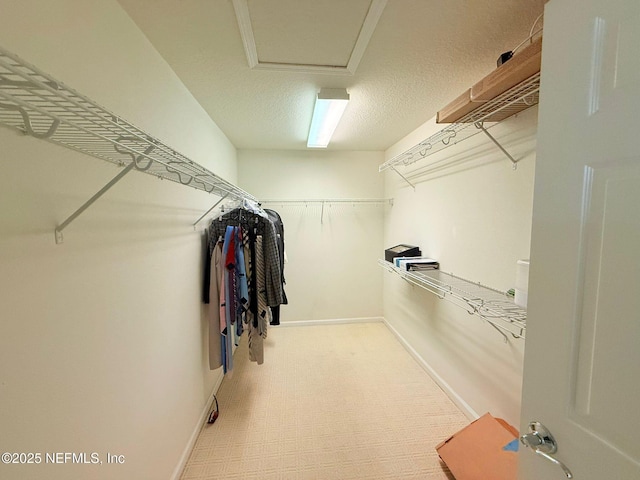 walk in closet featuring attic access