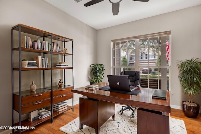 home office featuring visible vents, baseboards, ceiling fan, and wood finished floors