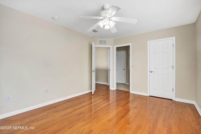 unfurnished bedroom featuring visible vents, baseboards, ceiling fan, and light wood finished floors