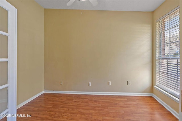 spare room with light wood-type flooring and ceiling fan