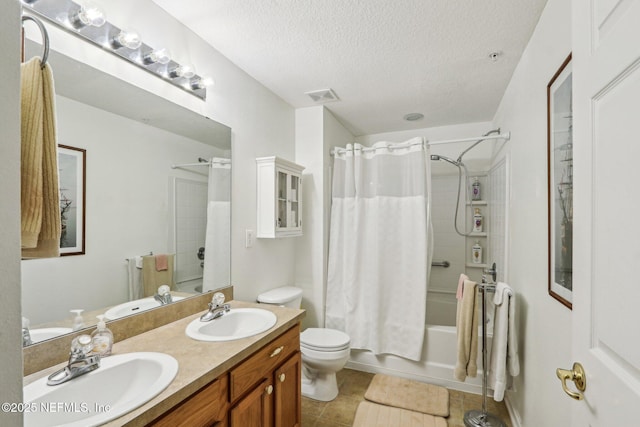 full bathroom featuring tile patterned flooring, vanity, toilet, shower / bathtub combination with curtain, and a textured ceiling