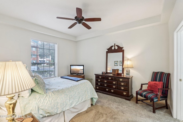 bedroom featuring light carpet and ceiling fan