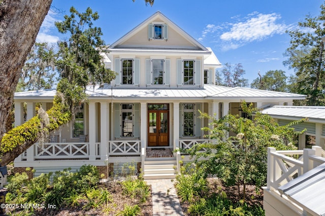 neoclassical / greek revival house featuring french doors and a porch