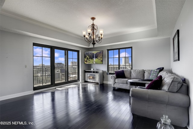 living room with a textured ceiling, a notable chandelier, and dark hardwood / wood-style floors