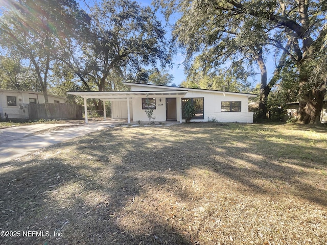 rear view of property with a yard and a carport