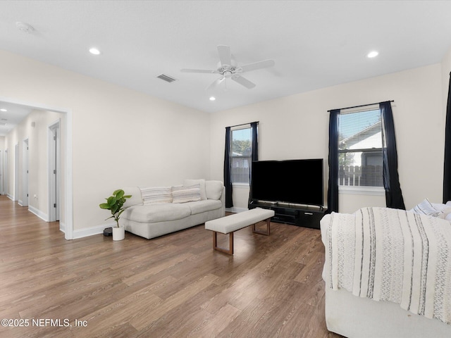 living room with hardwood / wood-style floors, ceiling fan, and a healthy amount of sunlight