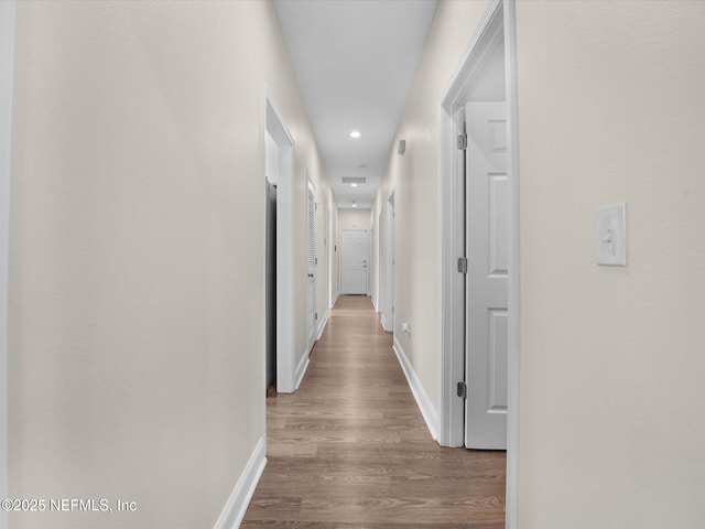 corridor with wood-type flooring