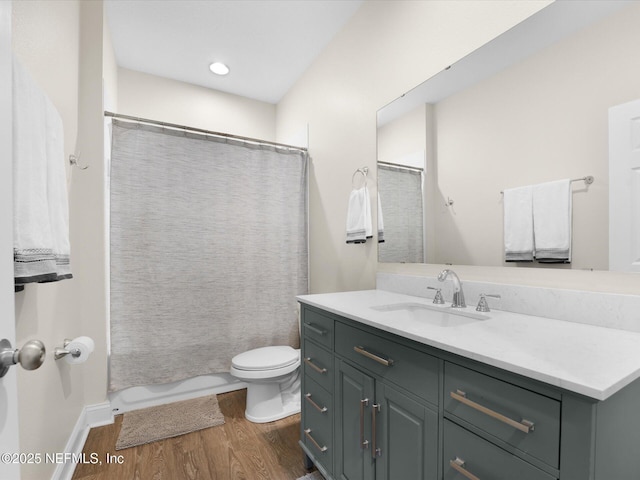 bathroom with curtained shower, toilet, vanity, and hardwood / wood-style flooring