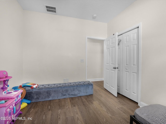 bedroom with hardwood / wood-style floors and a closet