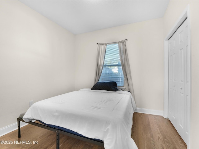 bedroom with a closet and hardwood / wood-style flooring