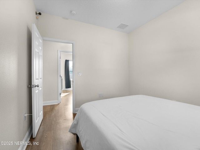 bedroom with hardwood / wood-style flooring