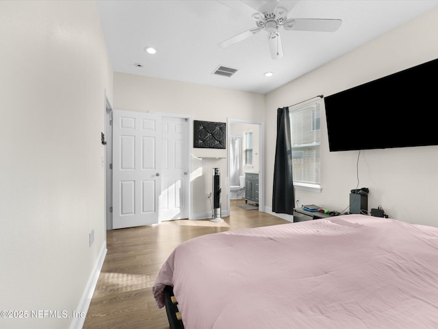 bedroom featuring ceiling fan, light wood-type flooring, and ensuite bathroom