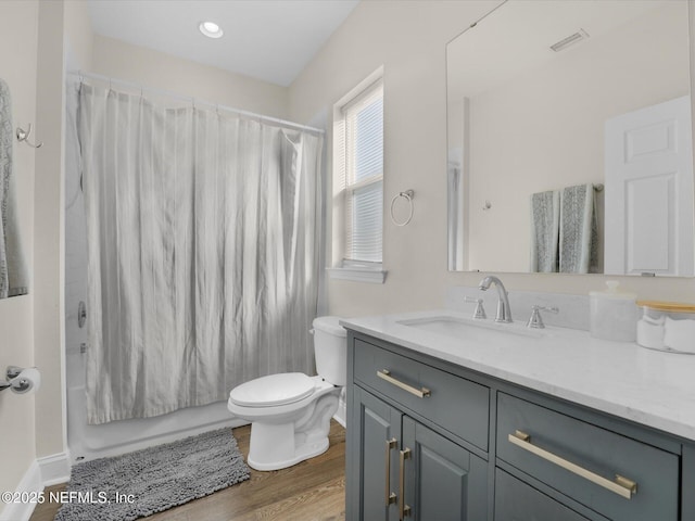 full bathroom featuring shower / tub combo, vanity, hardwood / wood-style flooring, and toilet