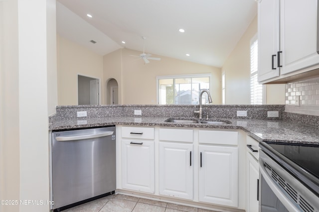 kitchen featuring white cabinetry, stainless steel appliances, sink, and dark stone counters