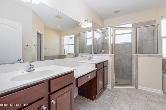 bathroom with vanity, tile patterned flooring, and a shower with door