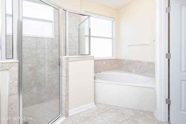 bathroom featuring plus walk in shower and tile patterned flooring