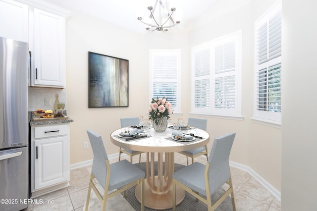 dining area featuring a notable chandelier and light tile patterned floors