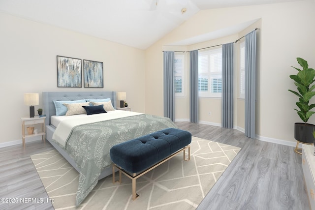 bedroom featuring lofted ceiling and light hardwood / wood-style floors