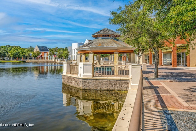 view of dock featuring a gazebo and a water view