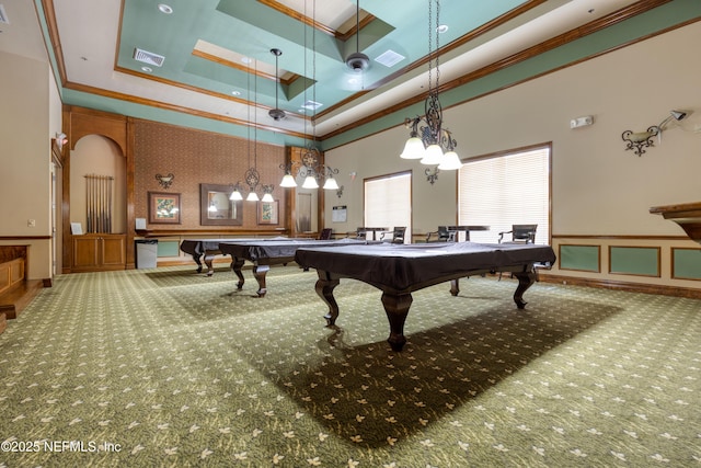 playroom featuring ornamental molding, a raised ceiling, a high ceiling, and carpet flooring