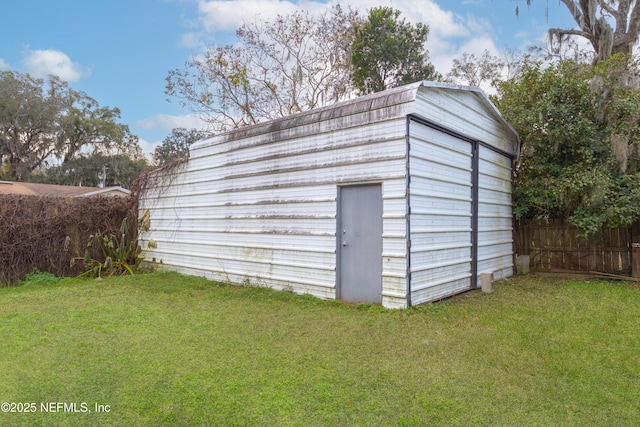 view of outbuilding featuring a lawn