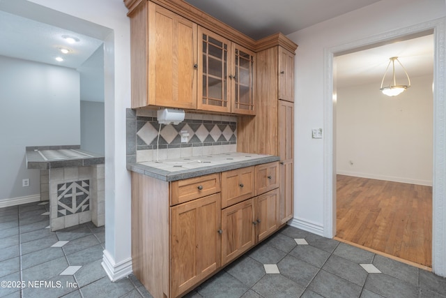 kitchen featuring pendant lighting, tile patterned floors, and tasteful backsplash