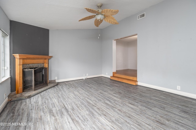 unfurnished living room featuring ceiling fan and wood-type flooring