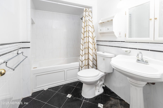 bathroom with tile patterned floors, tile walls, toilet, and shower / tub combo