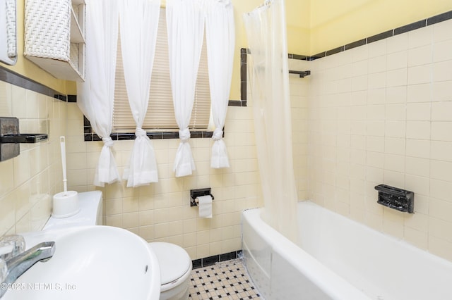 full bathroom featuring tile patterned floors, sink, tile walls, toilet, and shower / bath combo