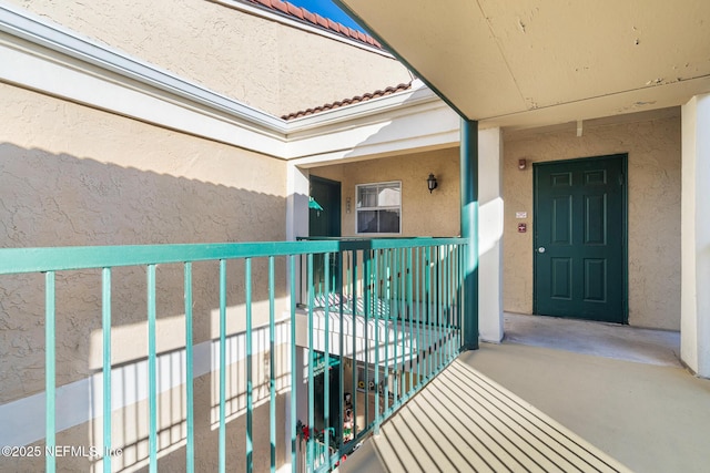 view of exterior entry featuring a balcony