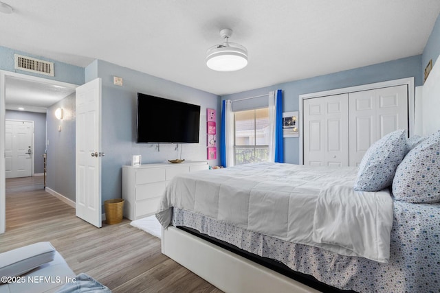 bedroom featuring light wood-type flooring and a closet