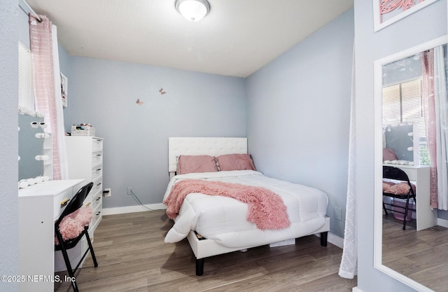 bedroom with hardwood / wood-style floors