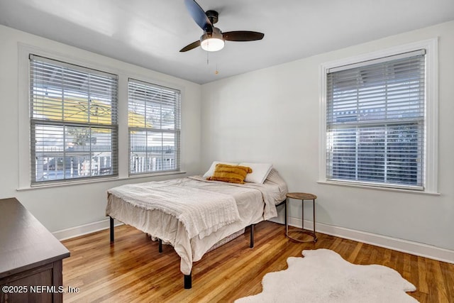 bedroom with ceiling fan and light hardwood / wood-style flooring