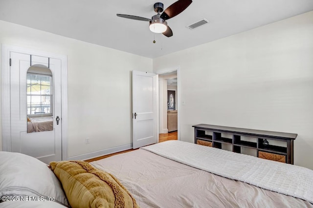 bedroom with hardwood / wood-style flooring and ceiling fan