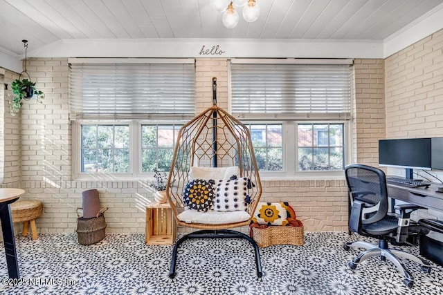 home office featuring crown molding and brick wall