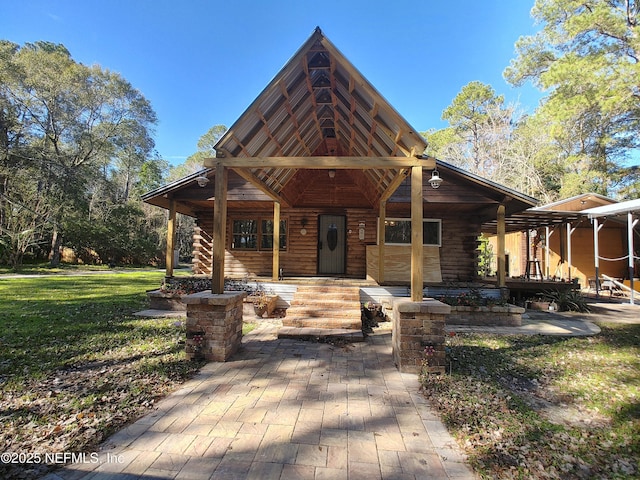 log cabin featuring a front yard