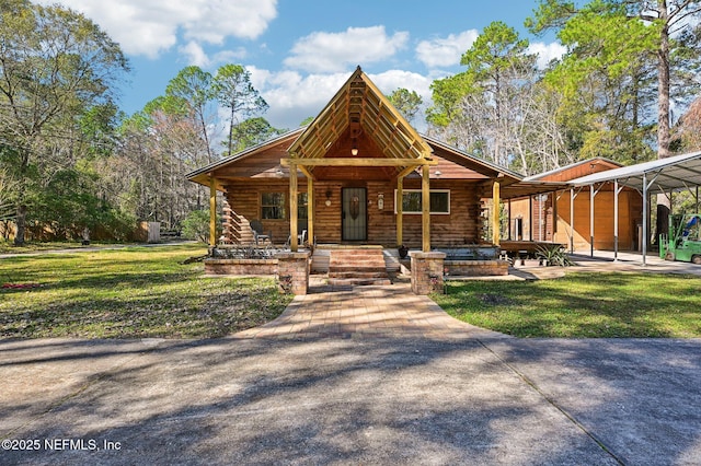 view of front of property with a garage, a front yard, a carport, and a porch