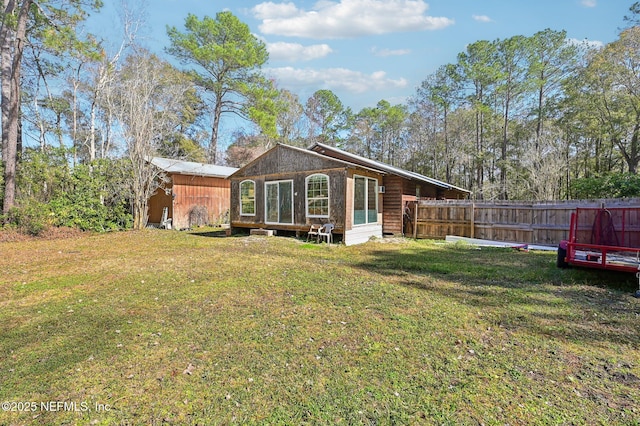 rear view of property featuring a lawn