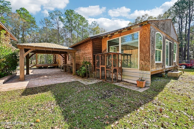 view of front facade featuring a gazebo, a patio area, and a front yard