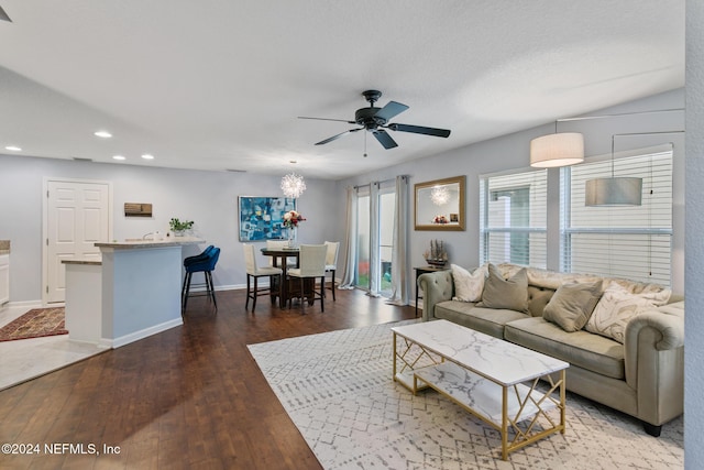 living room featuring ceiling fan and dark hardwood / wood-style floors