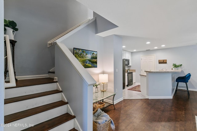 stairway featuring hardwood / wood-style floors