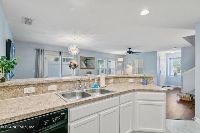 kitchen with white cabinetry, sink, black dishwasher, decorative light fixtures, and ceiling fan with notable chandelier